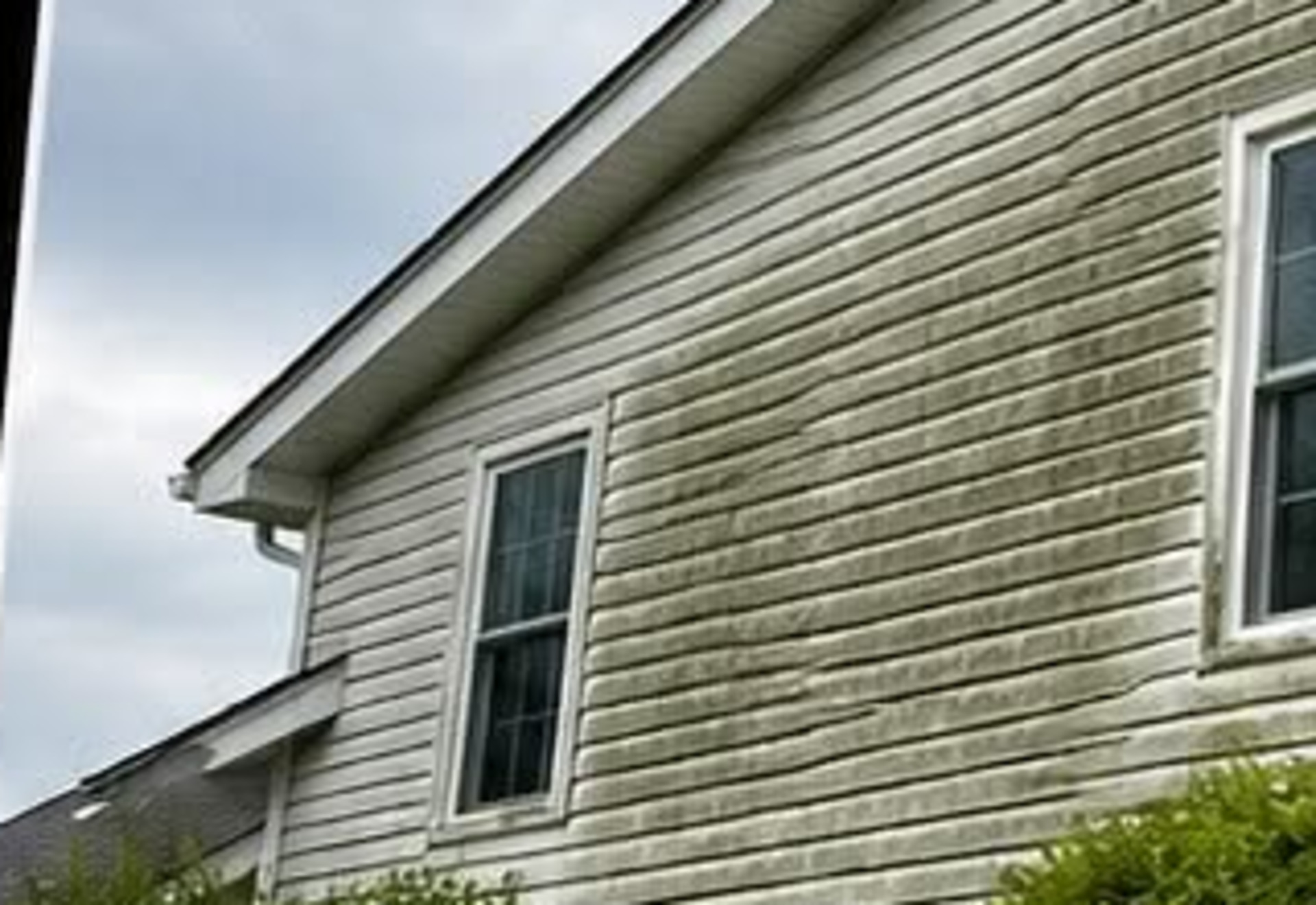 House washing on South Coast vinyl siding — before cleaning